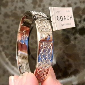 Nwt COACH silver plated bangle bracelet with signature C's.